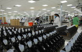 Workers at a factory making Enphase microinverters.